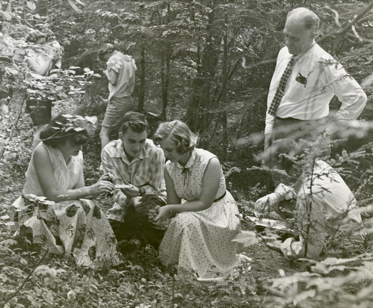 archival image of a professor and his students studying nature