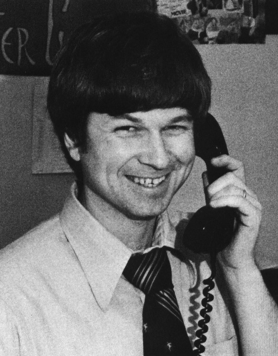 Vintage black-and-white photograph of John P. Clark ’71 '73G smiling on a phone call