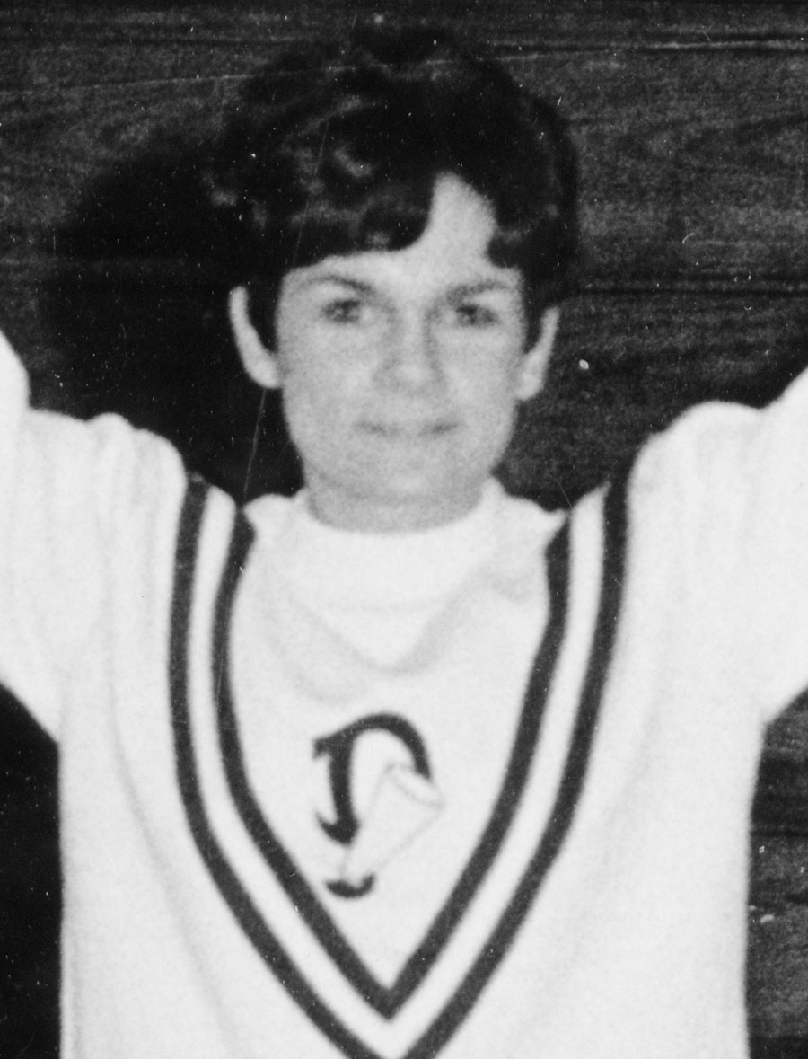 Vintage black-and-white photograph of Professor Emerita Louise Samaha McCormack '72 doing cheer