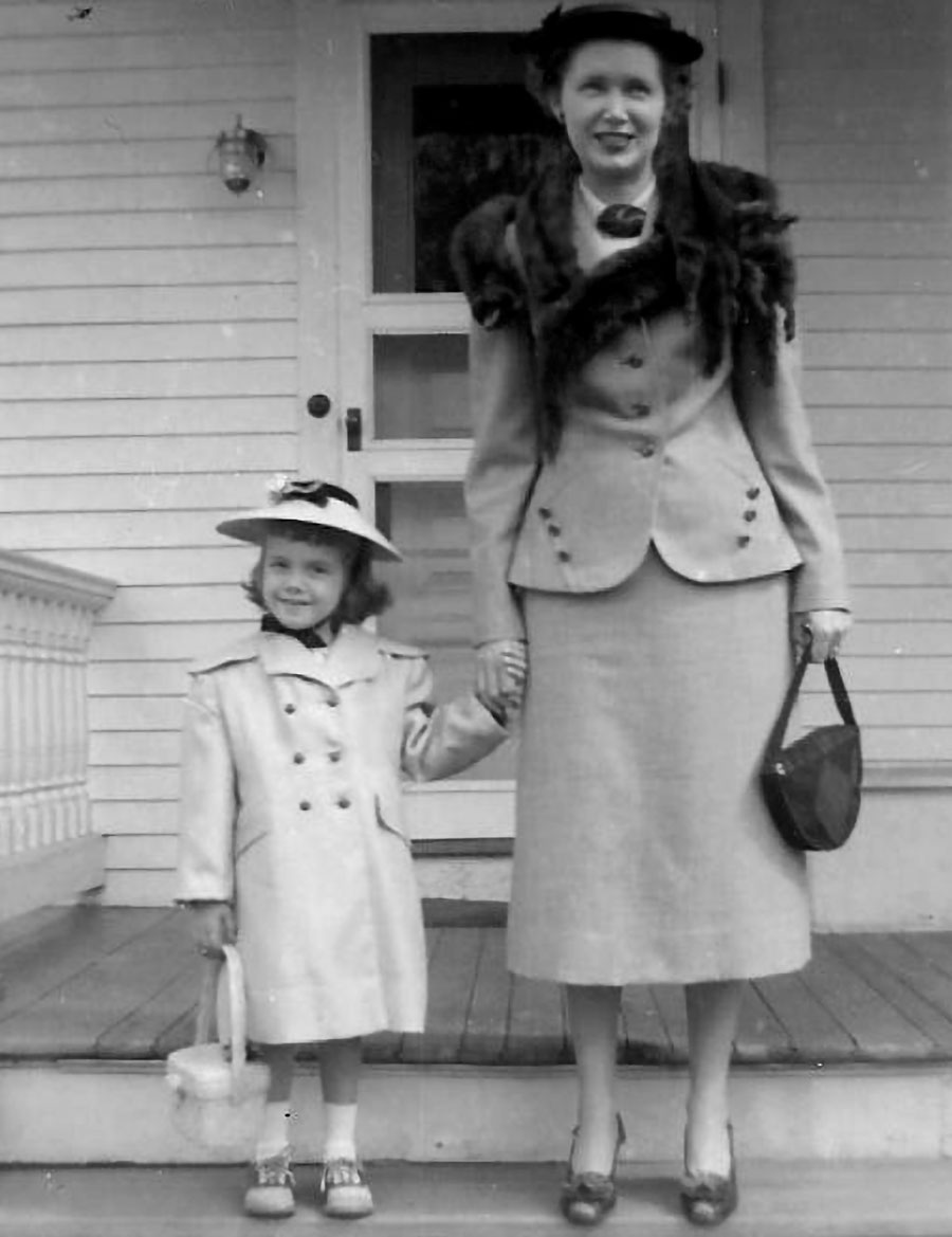 Vintage black-and-white photograph of the wife and daughter of President Harold Hyde standing in their Sunday best on some porch steps