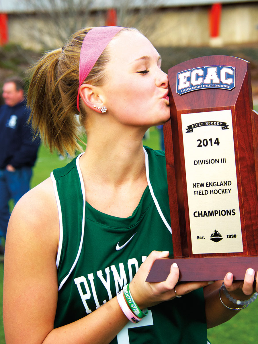Student holding ECAC 2014 Field Hockey Division Champions trophy