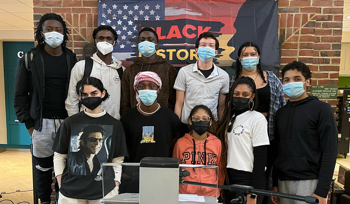 Black students standing together wearing masks