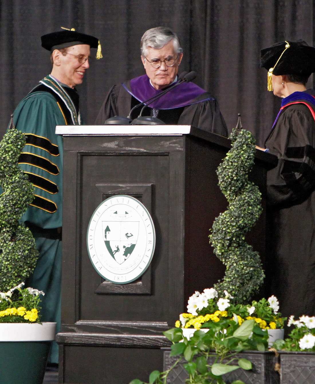 Professors standing at the commencement podium