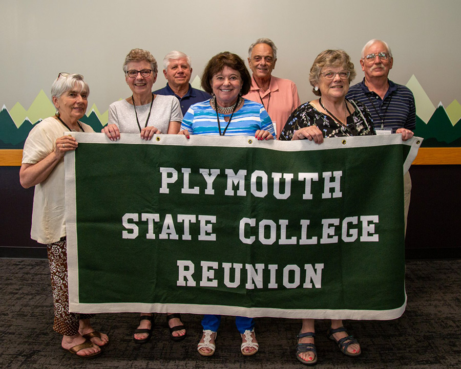 A group of seven individuals smile at the Plymouth State College Class of 1972 50th Reunion.