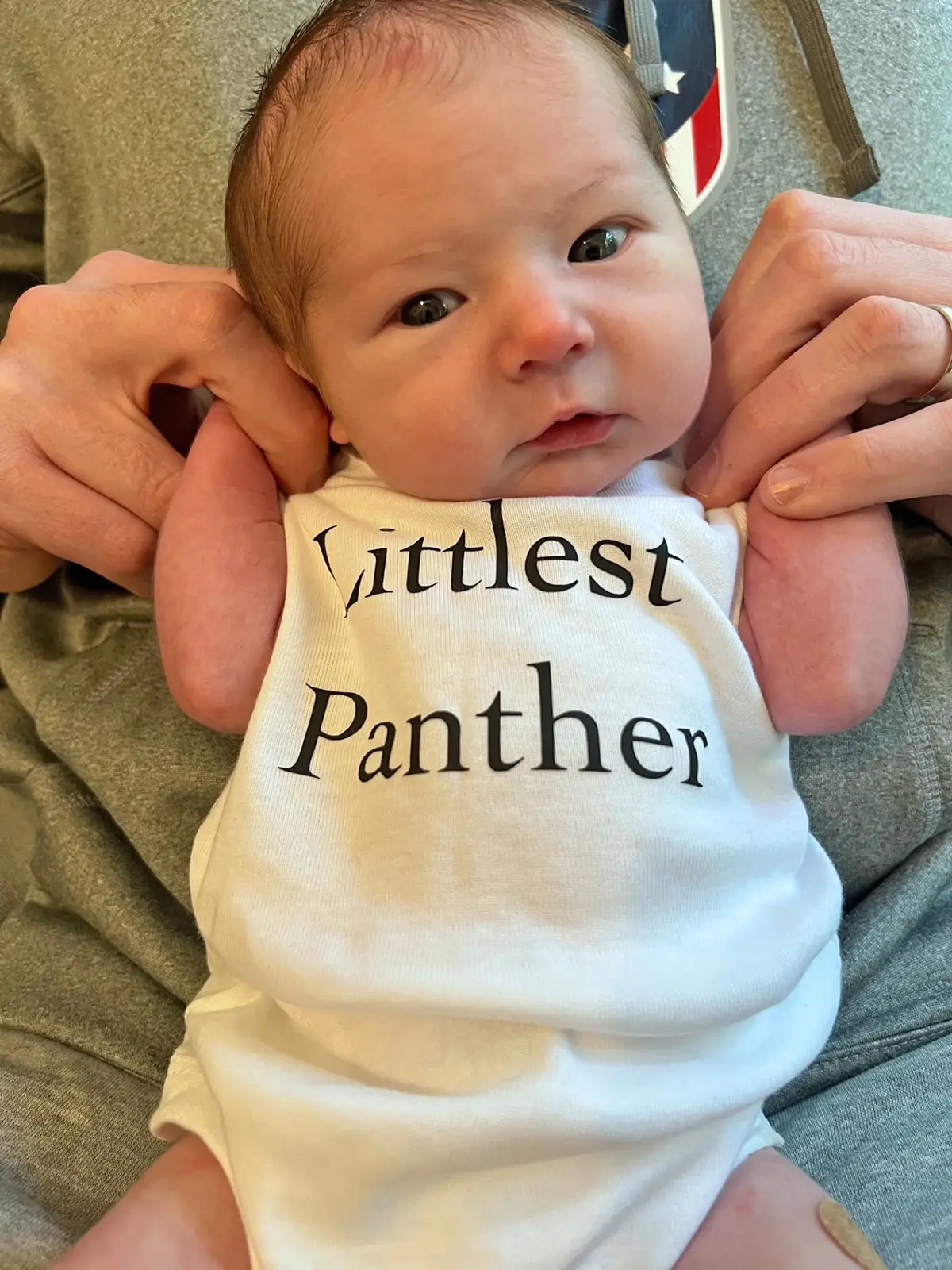 Baby Carter Whaland wearing onesie that reads Littlest Panther
