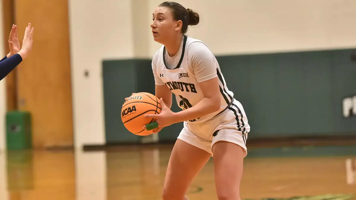 Bri Wilcox holding a basketball in the middle of a match