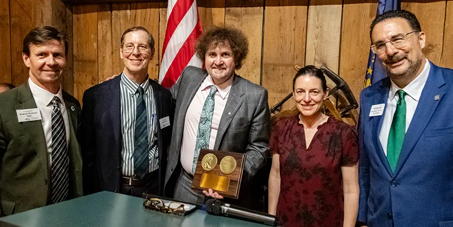 Tom Raffio takes a picture with University President Dr. Donald L. Birx and two other members of faculty