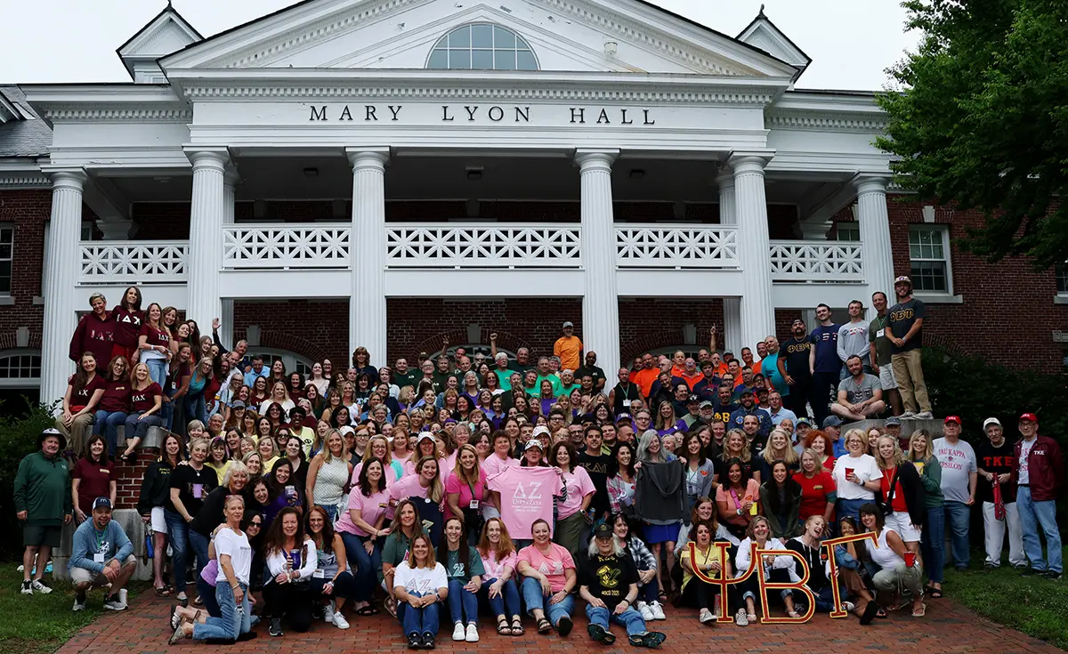 attendees of the Greek Alumni Reunion Weekend standing on the steps of Mary Lyon Hall for a large group photo