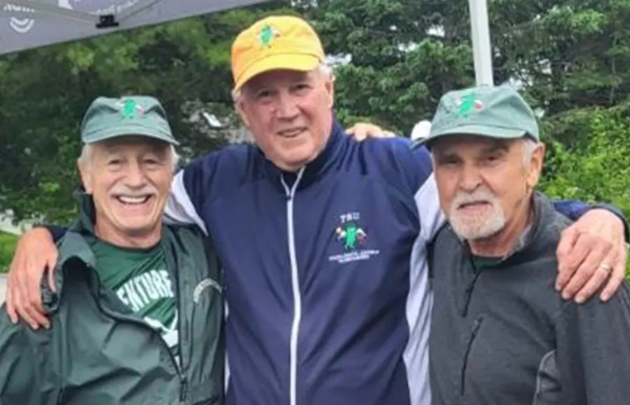 Wayne Semprini '72 and two other alumni leaning in together for a photo at the 3rd Annual Pickleball Angels Tournament