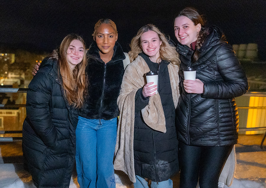 four female student smiling for group photo